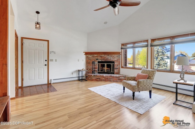 4230 Woronzof Dr # D, Anchorage, AK 99517 - living room with a baseboard heating unit, high vaulted ceiling, light wood-style flooring, a ceiling fan, and a brick fireplace