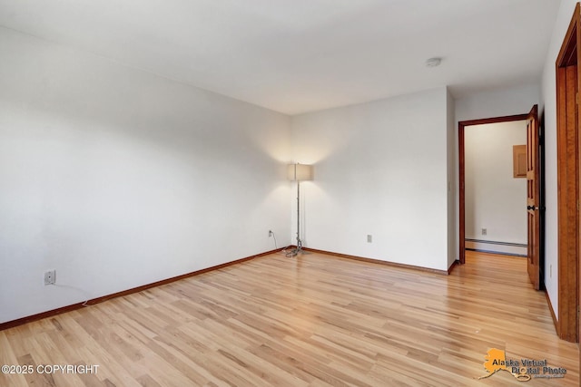 4230 Woronzof Dr # D, Anchorage, AK 99517 - empty room featuring baseboard heating, light wood-style floors, and baseboards