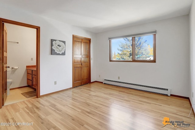 4230 Woronzof Dr # D, Anchorage, AK 99517 - unfurnished bedroom with a baseboard heating unit, light wood-style floors, connected bathroom, baseboards, and a closet