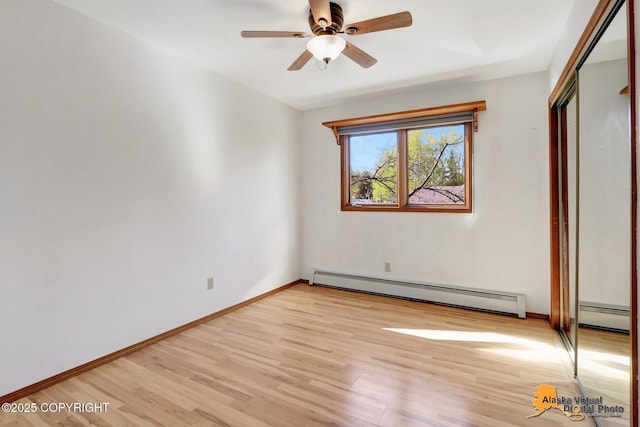 4230 Woronzof Dr # D, Anchorage, AK 99517 - unfurnished bedroom with baseboard heating, light wood finished floors, baseboards, and a closet