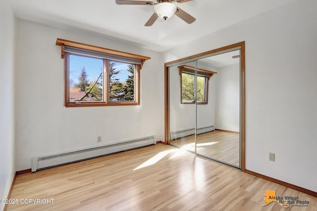 4230 Woronzof Dr # D, Anchorage, AK 99517 - unfurnished bedroom with a baseboard radiator, multiple windows, and a closet