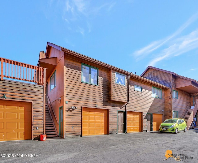 4230 Woronzof Dr # D, Anchorage, AK 99517 - view of front facade featuring stairway and a garage