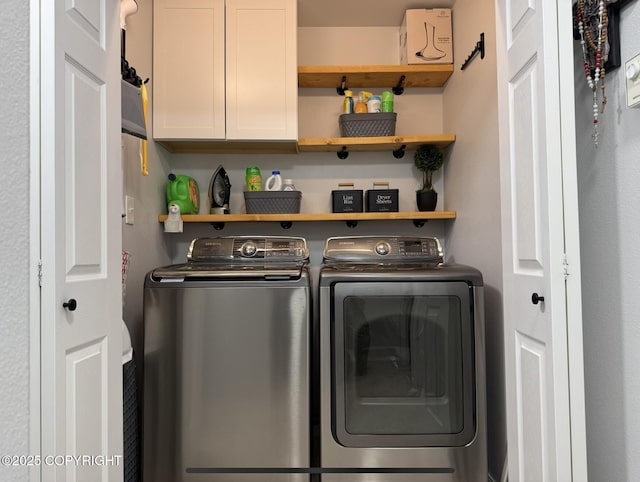 washroom with cabinet space and washer and clothes dryer