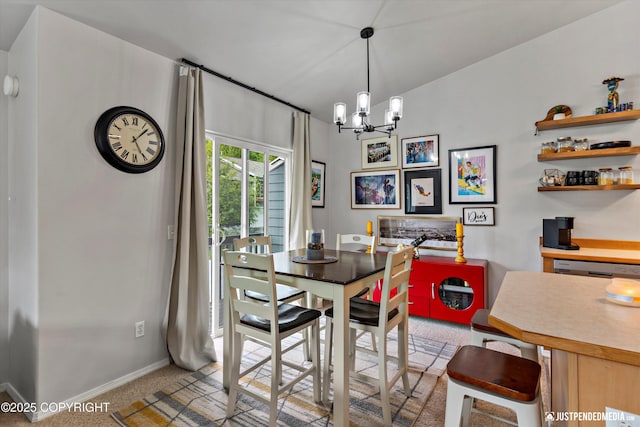 dining area featuring light colored carpet, a chandelier, and baseboards