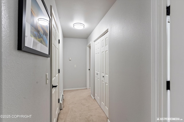 hall with light carpet and baseboards
