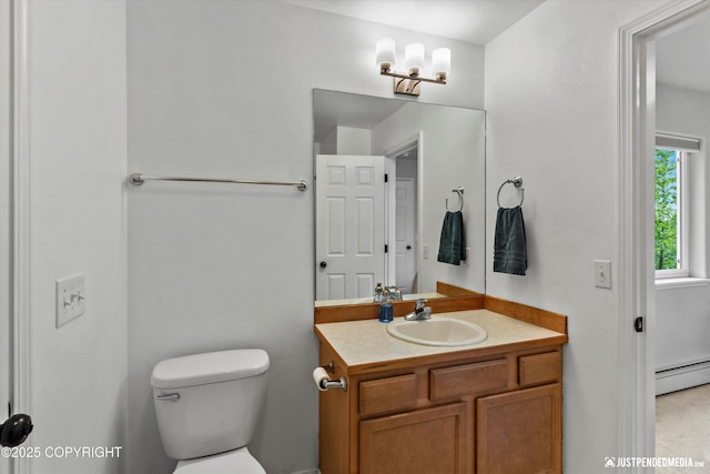 bathroom with a baseboard radiator, toilet, and vanity