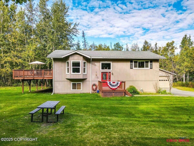 2750 E Whispering Woods Dr, Wasilla, AK 99654 - back of house with a wooden deck, a yard, a garage, and driveway