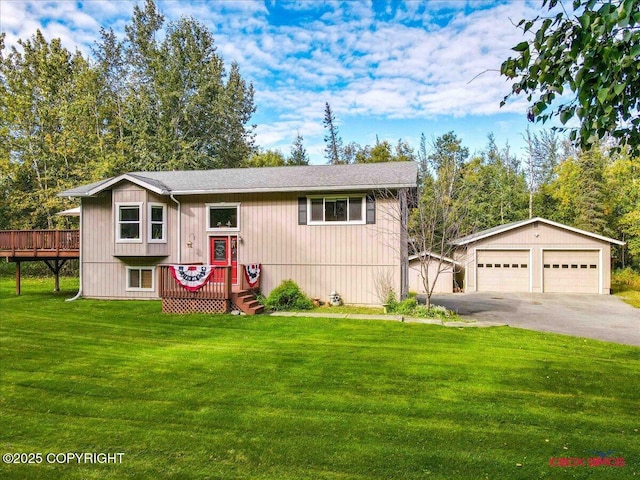 2750 E Whispering Woods Dr, Wasilla, AK 99654 - view of front of home with a detached garage, an outdoor structure, a front yard, a deck, and roof with shingles
