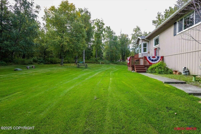 2750 E Whispering Woods Dr, Wasilla, AK 99654 - view of grassy yard with a wooden deck