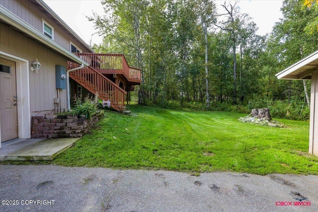 2750 E Whispering Woods Dr, Wasilla, AK 99654 - view of green lawn featuring stairs and a wooden deck