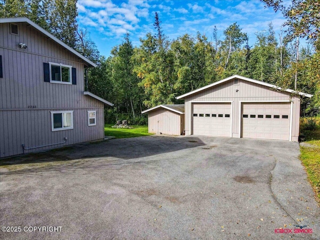 2750 E Whispering Woods Dr, Wasilla, AK 99654 - view of side of property with an outdoor structure and a garage