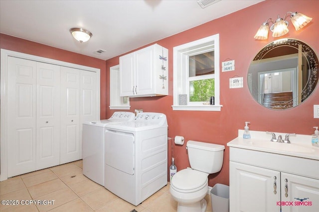 2750 E Whispering Woods Dr, Wasilla, AK 99654 - bathroom with washing machine and dryer, vanity, toilet, and tile patterned floors