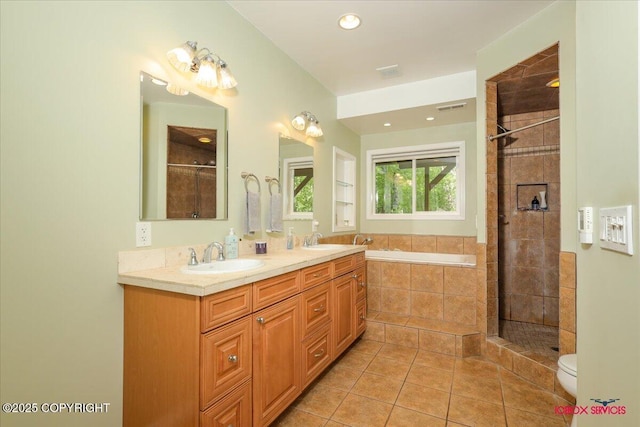 2750 E Whispering Woods Dr, Wasilla, AK 99654 - full bath with tile patterned flooring, double vanity, a garden tub, tiled shower, and toilet