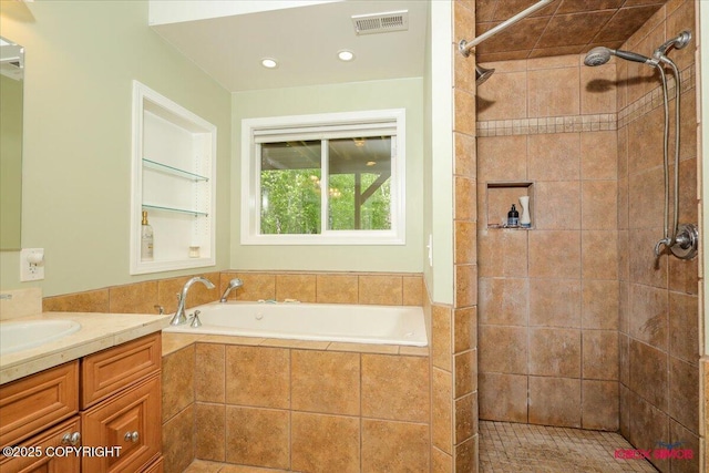 2750 E Whispering Woods Dr, Wasilla, AK 99654 - bathroom featuring a bath, vanity, tiled shower, and recessed lighting