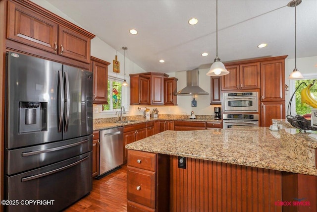 2750 E Whispering Woods Dr, Wasilla, AK 99654 - kitchen featuring appliances with stainless steel finishes, wall chimney range hood, a sink, recessed lighting, and light stone counters