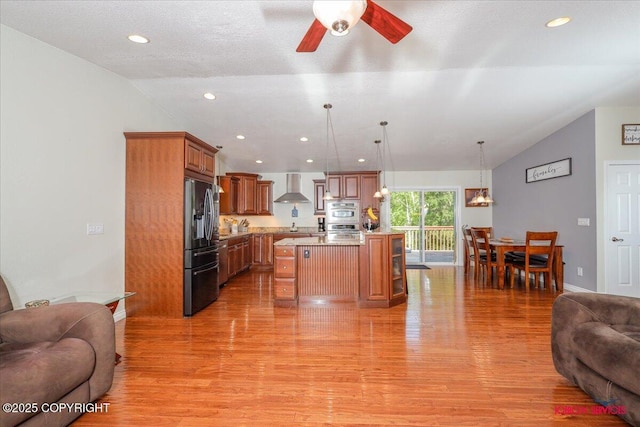 2750 E Whispering Woods Dr, Wasilla, AK 99654 - kitchen with open floor plan, wall chimney range hood, stainless steel appliances, light countertops, and lofted ceiling