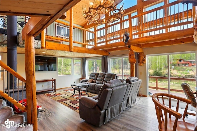 living area featuring a chandelier, wood finished floors, high vaulted ceiling, and wooden ceiling