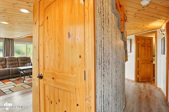 hall featuring wood ceiling, wood finished floors, and recessed lighting