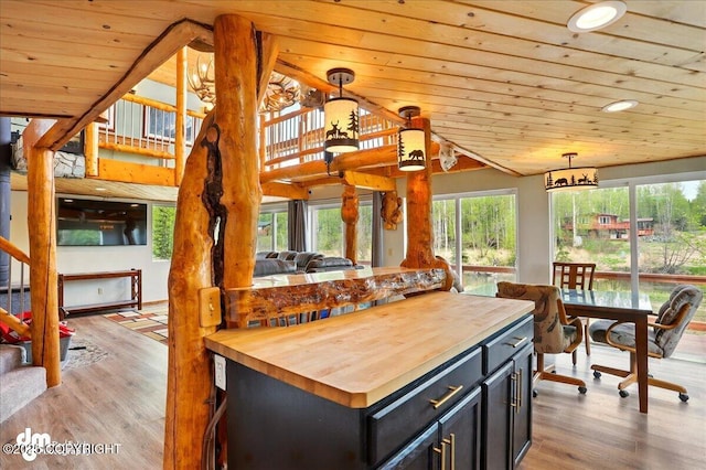 kitchen with wooden counters, wooden ceiling, light wood-style flooring, plenty of natural light, and recessed lighting