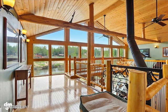 sunroom featuring a water view