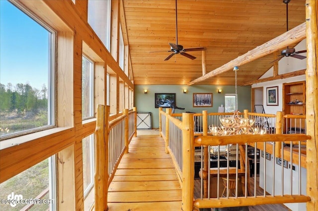 corridor with wooden ceiling, high vaulted ceiling, an upstairs landing, and wood finished floors