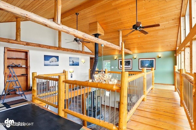 staircase with a ceiling fan, wood ceiling, hardwood / wood-style floors, and high vaulted ceiling