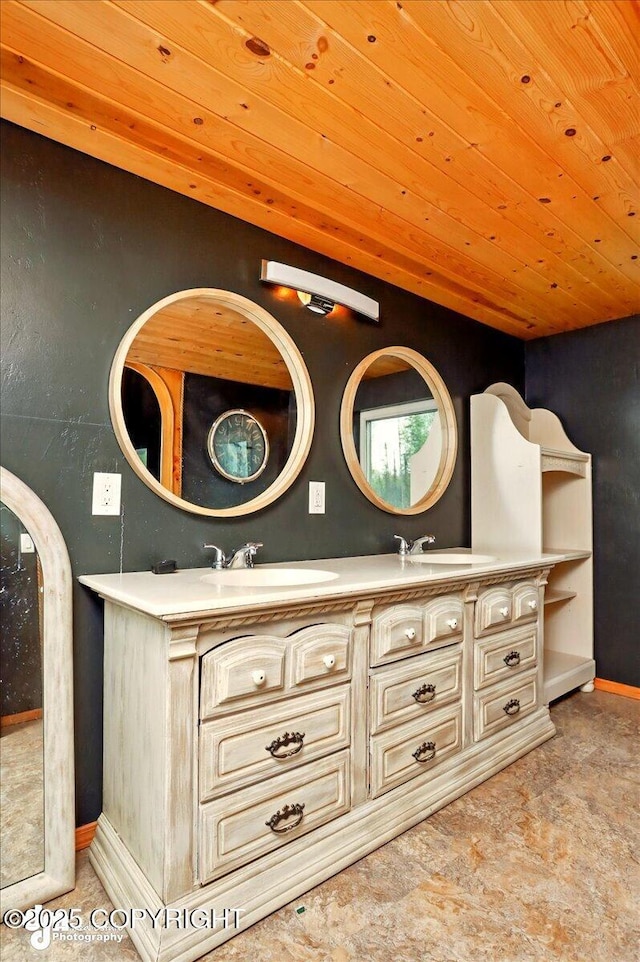 bathroom with wood ceiling, double vanity, and baseboards