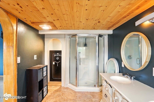 bathroom with wooden ceiling, a stall shower, and vanity