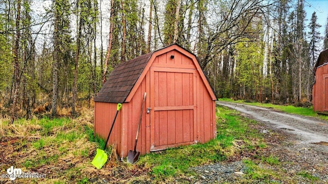 view of shed with a wooded view