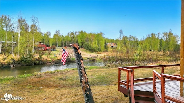 view of green lawn featuring a water view