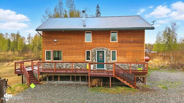 back of house with stairs, a wooden deck, and stone siding