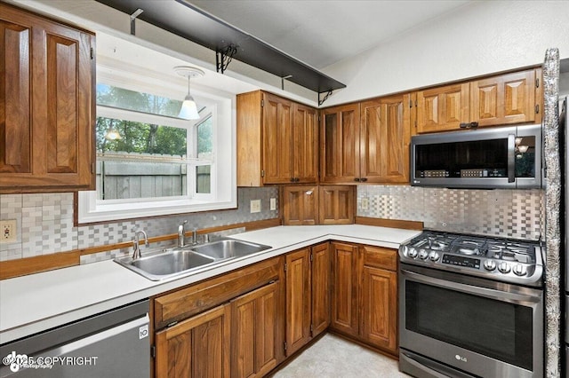 3337 Madison Way, Anchorage, AK 99508 - kitchen featuring appliances with stainless steel finishes, light countertops, brown cabinetry, and backsplash