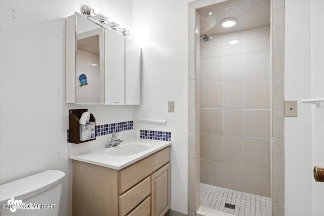 3337 Madison Way, Anchorage, AK 99508 - bathroom featuring tiled shower, vanity, and decorative backsplash