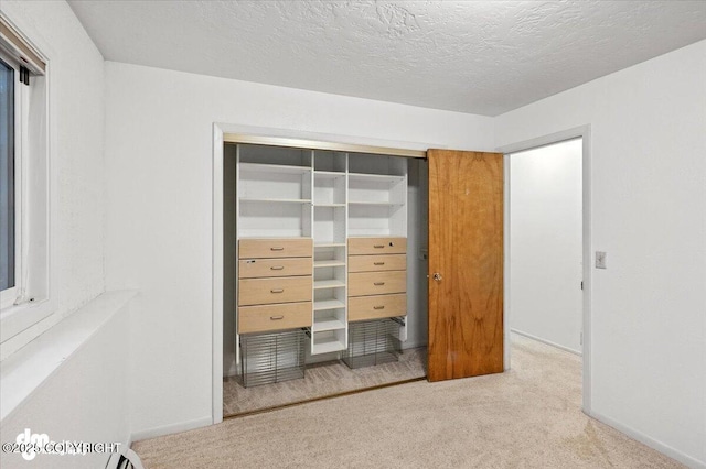 3337 Madison Way, Anchorage, AK 99508 - bedroom featuring carpet, a closet, and a textured ceiling