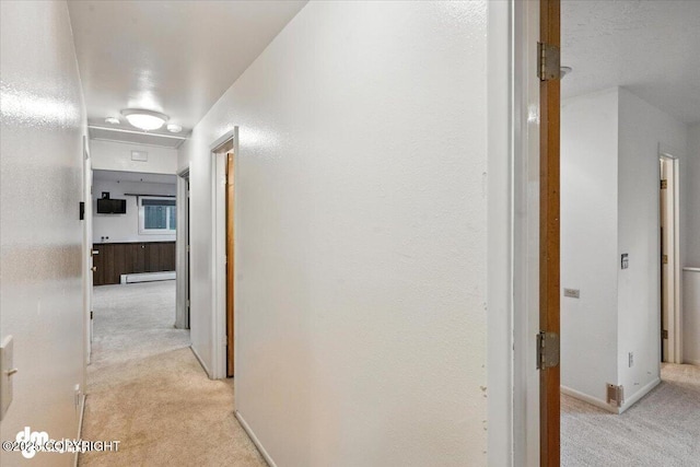 3337 Madison Way, Anchorage, AK 99508 - hallway with light colored carpet and baseboard heating