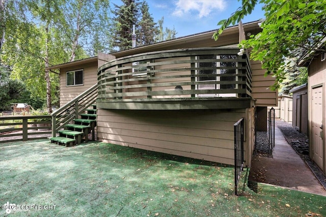 3337 Madison Way, Anchorage, AK 99508 - rear view of property with stairway, a wooden deck, and a lawn
