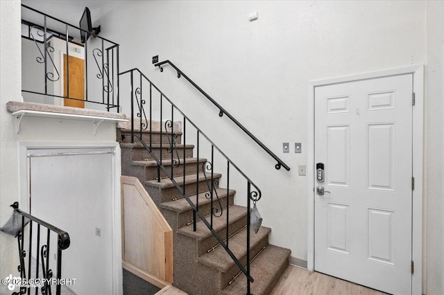 3337 Madison Way, Anchorage, AK 99508 - stairs featuring wood finished floors and baseboards