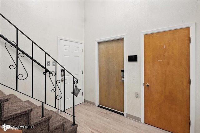 3337 Madison Way, Anchorage, AK 99508 - entryway featuring stairway, light wood finished floors, and a high ceiling