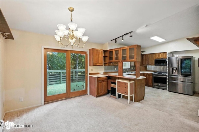 3337 Madison Way, Anchorage, AK 99508 - kitchen with stainless steel appliances, brown cabinetry, track lighting, a chandelier, and light carpet