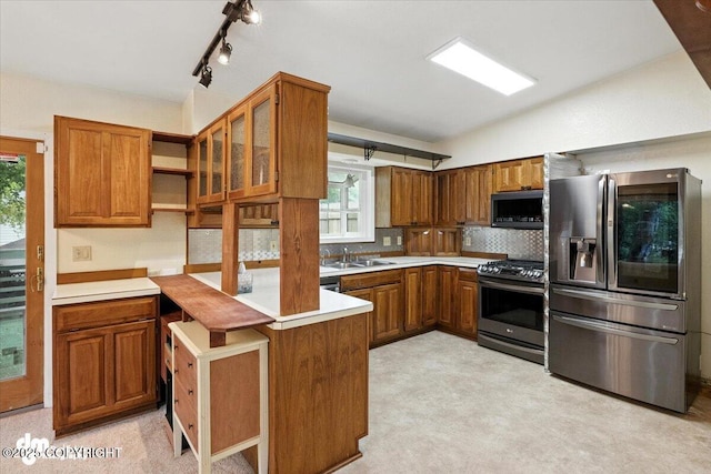 3337 Madison Way, Anchorage, AK 99508 - kitchen with appliances with stainless steel finishes, brown cabinets, open shelves, light countertops, and a peninsula
