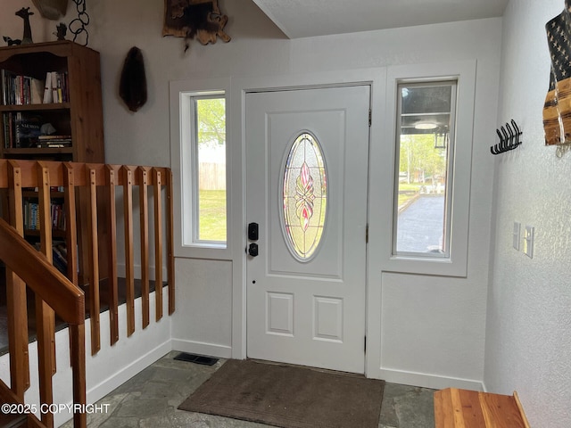 21675 Sheltering Spruce Loop, Chugiak, AK 99567 - foyer entrance featuring baseboards and dark stone finish floors