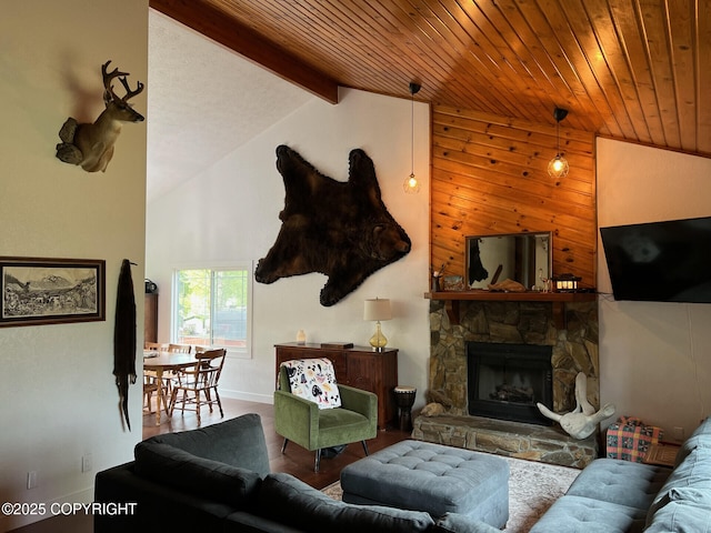 21675 Sheltering Spruce Loop, Chugiak, AK 99567 - living room featuring beamed ceiling, wood finished floors, a stone fireplace, high vaulted ceiling, and baseboards