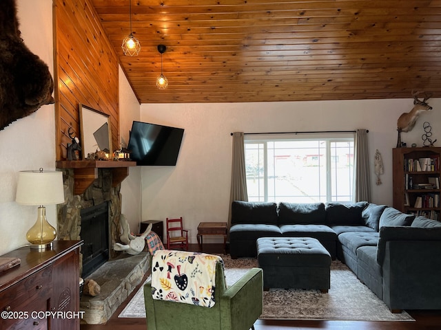 21675 Sheltering Spruce Loop, Chugiak, AK 99567 - living room featuring vaulted ceiling, wood ceiling, a stone fireplace, and wood finished floors