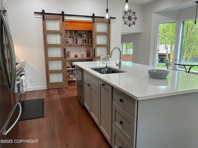 21675 Sheltering Spruce Loop, Chugiak, AK 99567 - kitchen with a sink, a barn door, gray cabinetry, dark wood-style floors, and light countertops