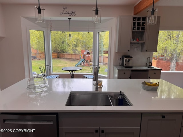 21675 Sheltering Spruce Loop, Chugiak, AK 99567 - kitchen with dishwashing machine, light countertops, a sink, and gray cabinets