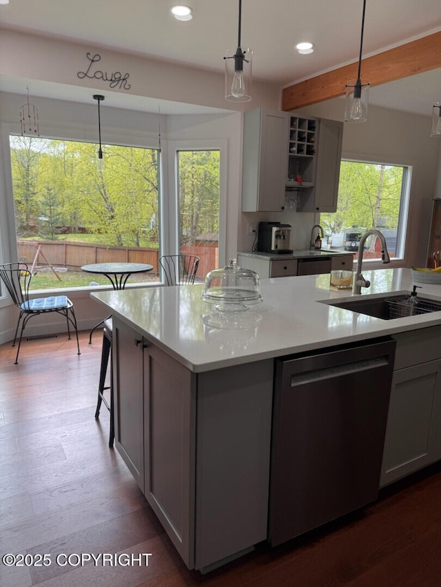 21675 Sheltering Spruce Loop, Chugiak, AK 99567 - kitchen featuring dishwasher, a sink, recessed lighting, light countertops, and hanging light fixtures