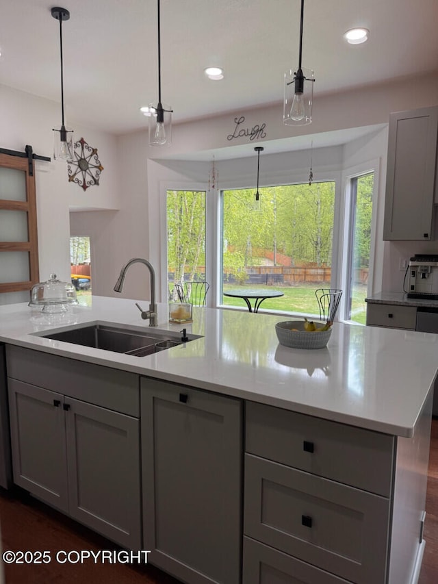 21675 Sheltering Spruce Loop, Chugiak, AK 99567 - kitchen with gray cabinetry, a sink, a barn door, recessed lighting, and decorative light fixtures