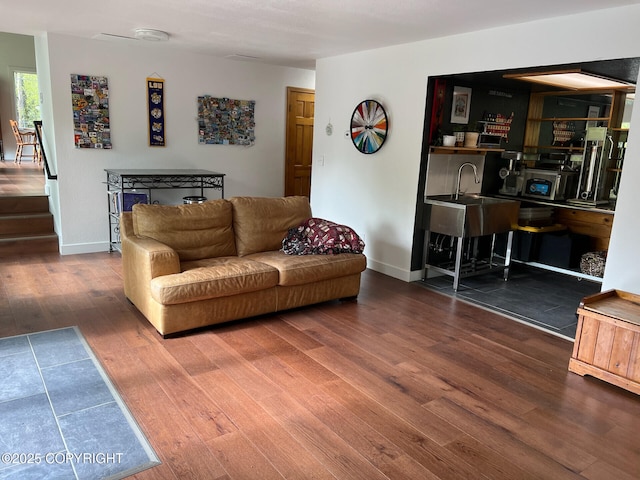 21675 Sheltering Spruce Loop, Chugiak, AK 99567 - living room featuring wood finished floors, baseboards, and stairway