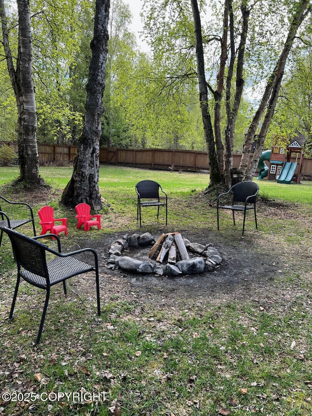 21675 Sheltering Spruce Loop, Chugiak, AK 99567 - view of yard featuring a playground and a fire pit
