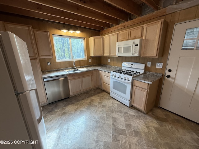 26155 W Long Lake Rd, Willow, AK 99688 - kitchen with white appliances, a sink, wood walls, light brown cabinets, and stone finish floors